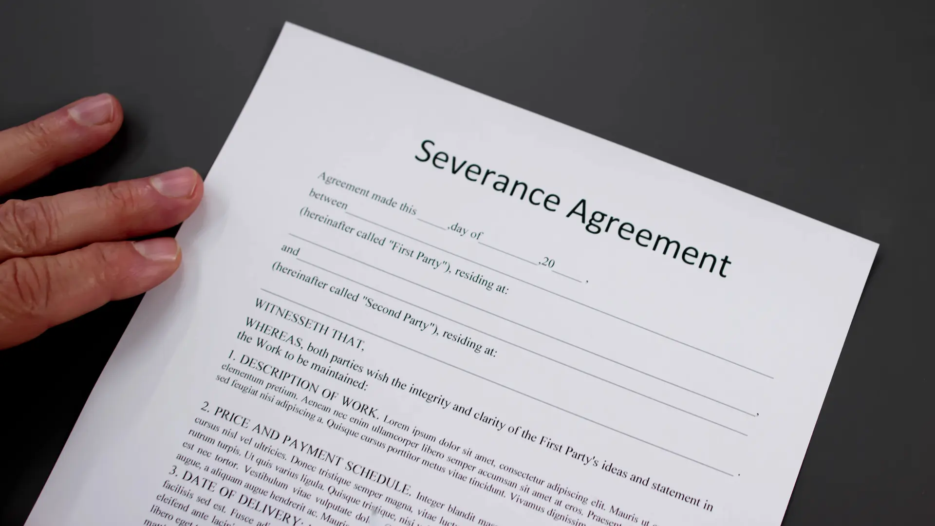 Employee reviewing severance payment options and compensation details on a computer screen with legal paperwork